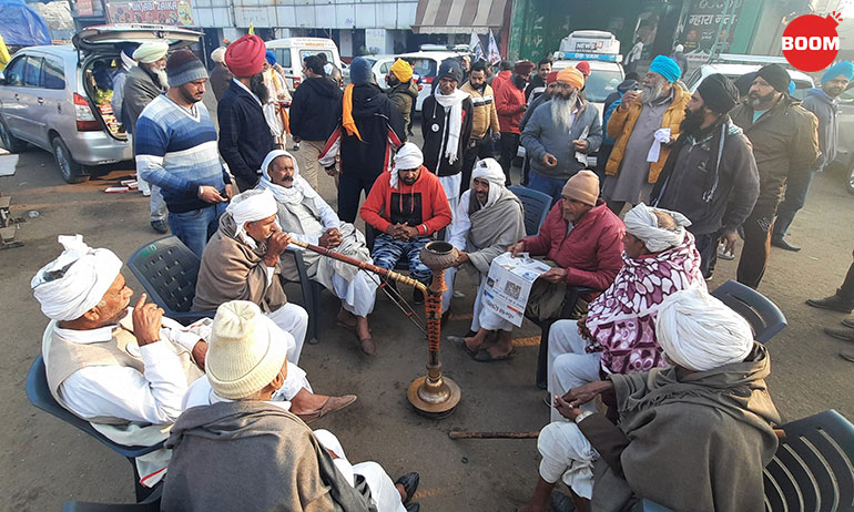A group of elderly jats from Haryana catch up on news during their early morning hukka session.