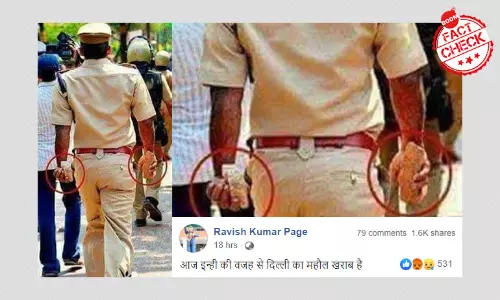Dated Picture Of Cop Holding Stones Spun As Police Violence In Delhi