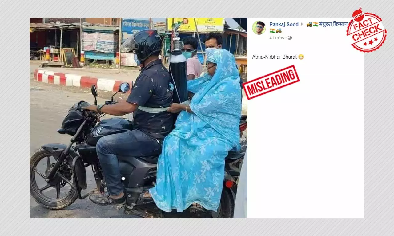 Image Of COVID Patient With Oxygen Cylinder On Bike Is From Bangladesh