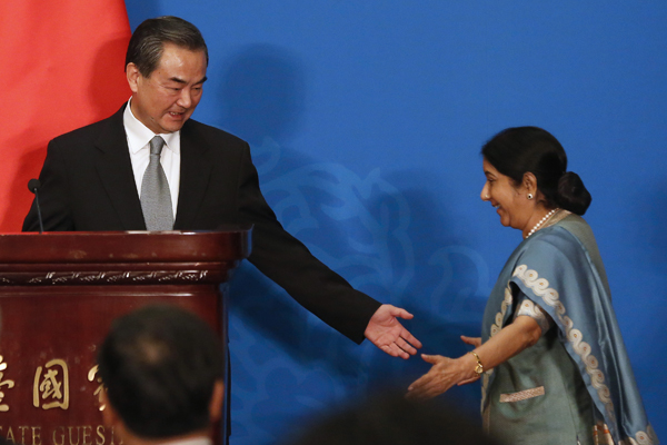 Chinese Foreign Minister Wang Yi with Indian Foreign Minister Sushma Swaraj at the 13th Russia-India-China Foreign Ministers' Meeting in Beijing. Source: Reuters