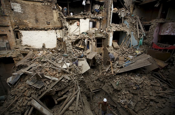 People search for family members trapped inside collapsed houses a day after the earthquake in Bhaktapur, Nepal. Rescuers dug with their bare hands and bodies piled up in Nepal on Sunday after the earthquake devastated the heavily crowded Kathmandu valley. (Source: REUTERS/Navesh Chitrakar)
