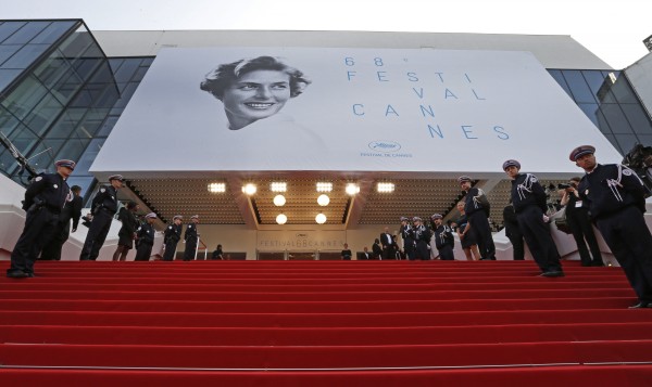 French police officers stand at attention before arrivals on the red carpet for the opening ceremony and the screening of the film 