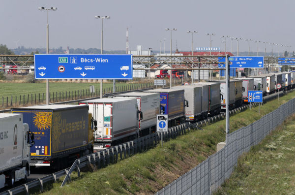 Trucks stand in a queue along a highway near the Austrian border in Hegyeshalom