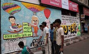 Image shows local artists making a political graffiti on a wall 