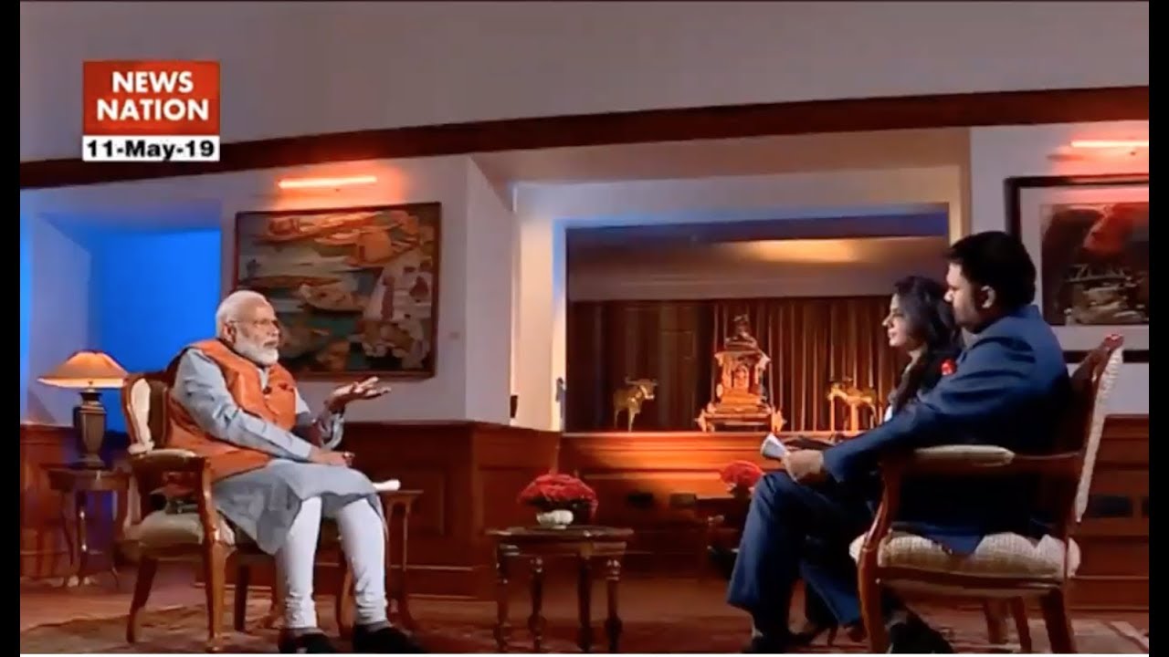 Image shows Modi standing in front of Matrix-like graphics