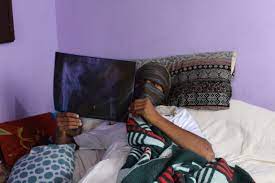 An injured teenager shows his X-Ray with signs of pellets injuries at his home in Soura, Srinagar